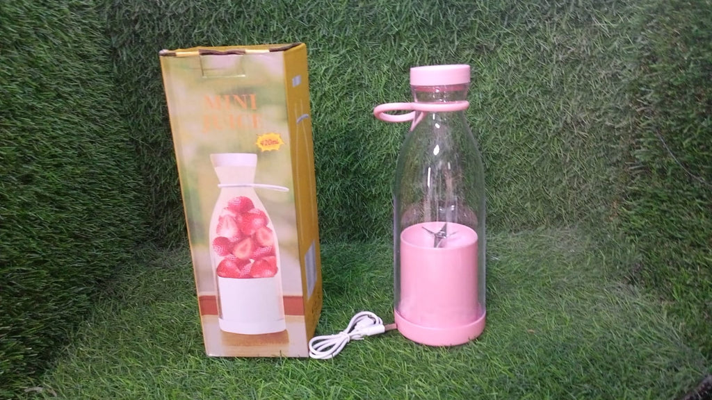 Dabster portable juicer blender surrounded by fresh fruits and vegetables.